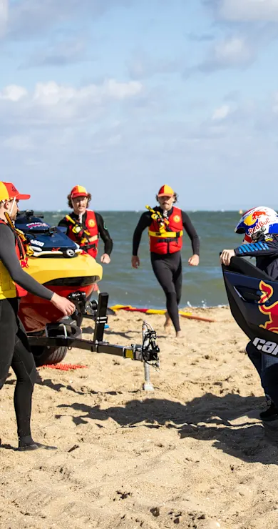 Carousel Slide Image of Formula One drivers race as Australian surf lifesavers