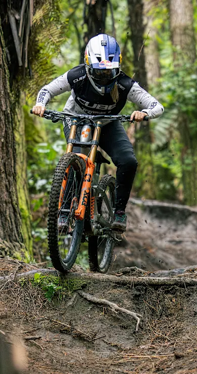 Carousel Slide Image of Jess Blewitt freeriding through the ferns of New Zealand